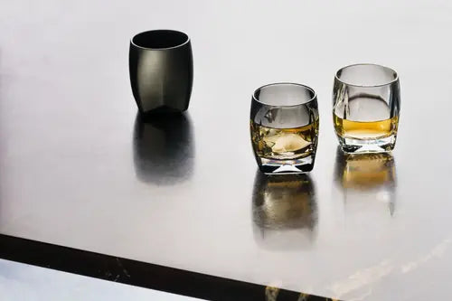 A lifestyle image showing all three colors of the Rauk heavy Tumbler, 250 mL by Norlan. From left to right VAILD (Black), Sinder (Grey), Clear.