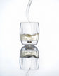 Norlan Rauk Heavy Tumbler 250 mL (Clear) with whisky being poured, reflected on a light background.