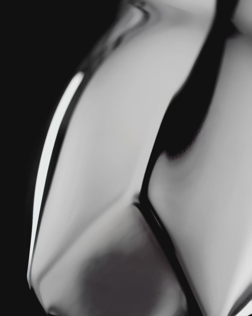The Norlan Steel Tumbler in gleaming polished stainless steel rotating in air to reveal all the angles and sides of the glass.